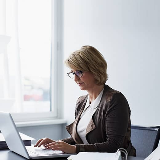 Woman Typing on a Laptop