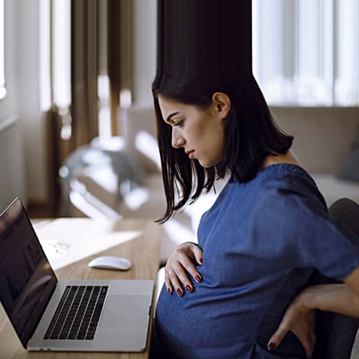 Pregnant Woman Looking at a Computer